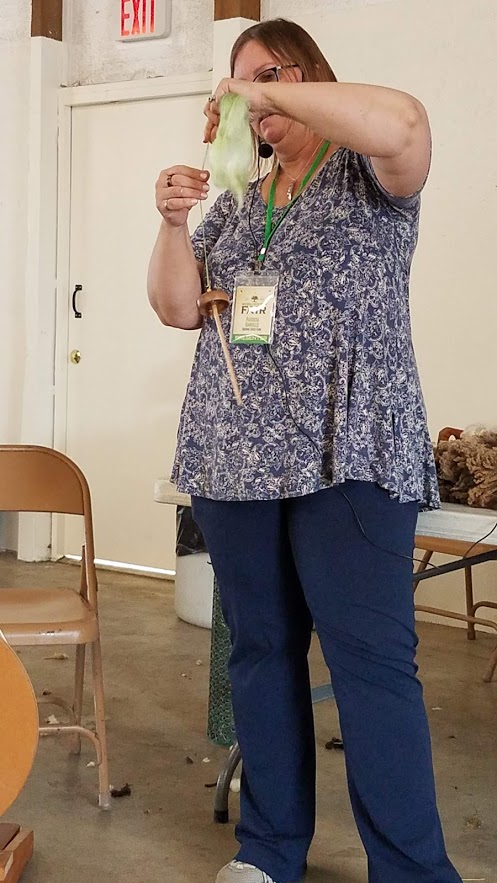 Patty demonstrates drop spinning with a Spanish Peacock spindle