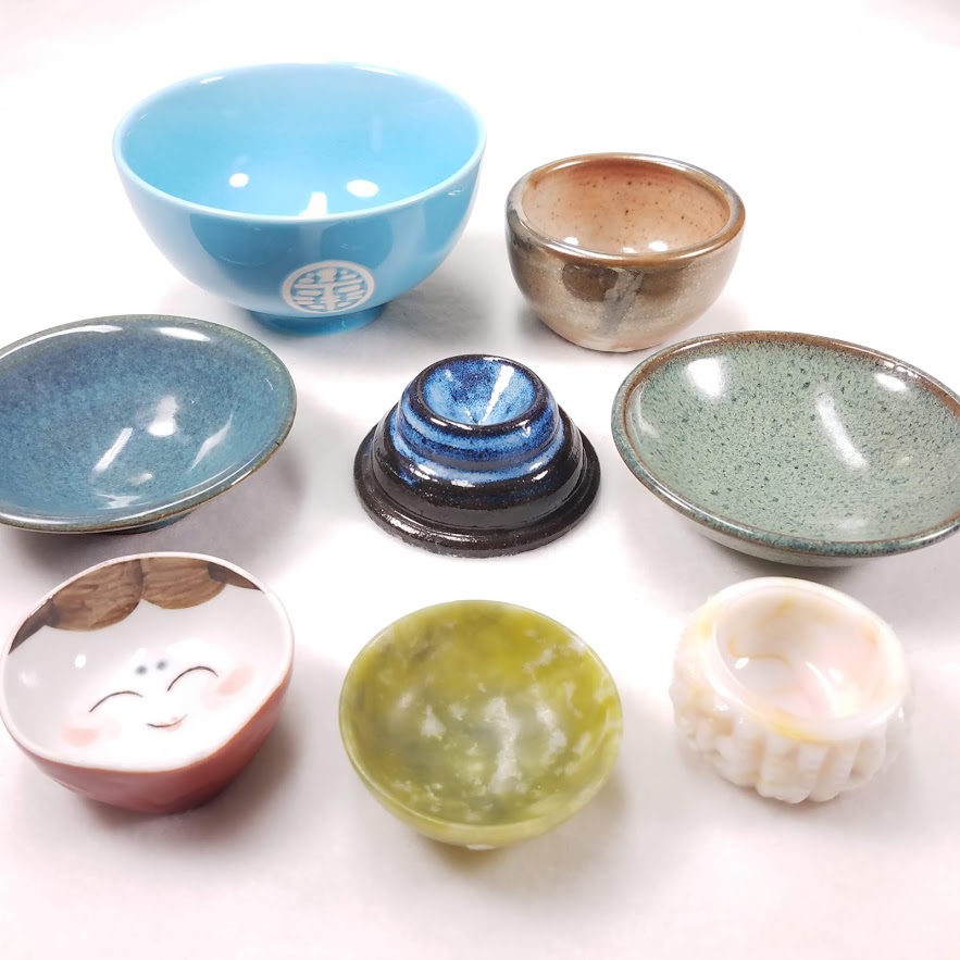 A variety of ceramic, glass, and stone supported spindle bowls