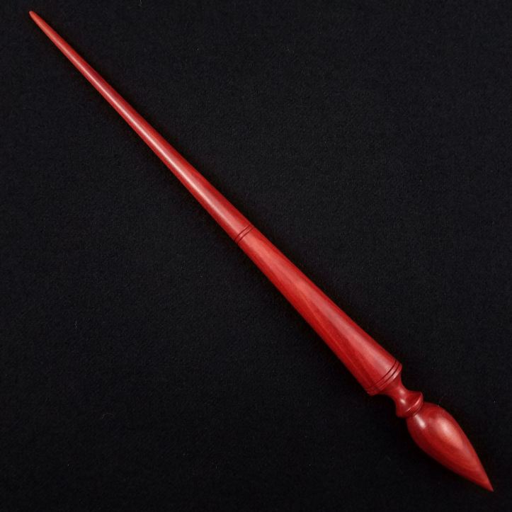 A Spanish Peacock pocket Russian lace spindle in redheart