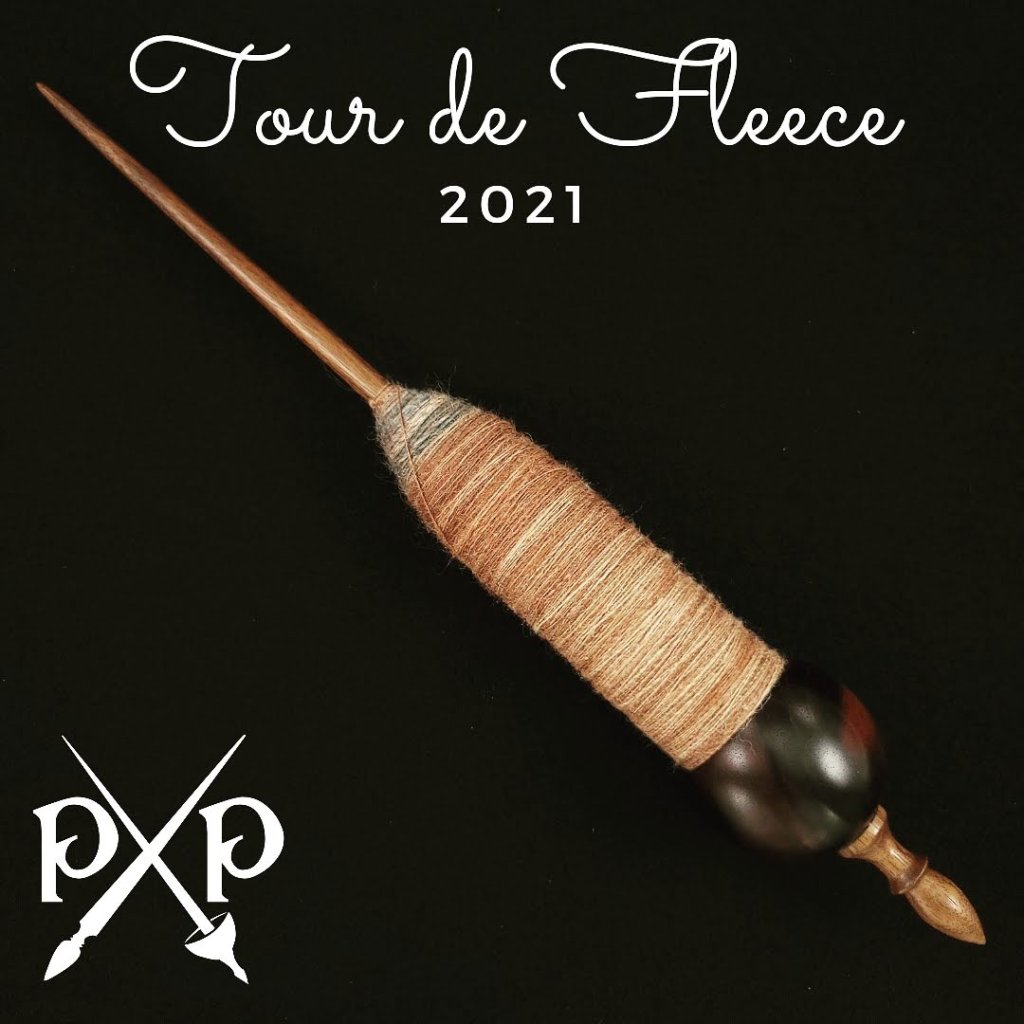 First Win of Tour de Fleece 2021! A Spanish Peacock supported spindle full of spun singles yarn.