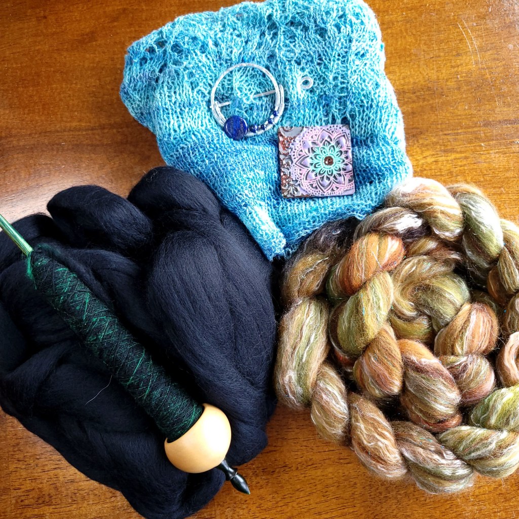 SVFF loot - two shawl pins, a brown and green braid, and straight black merino