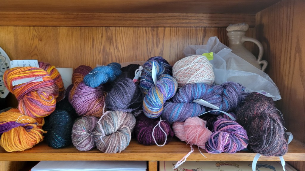 A pile of handpsun skeins on a shelf