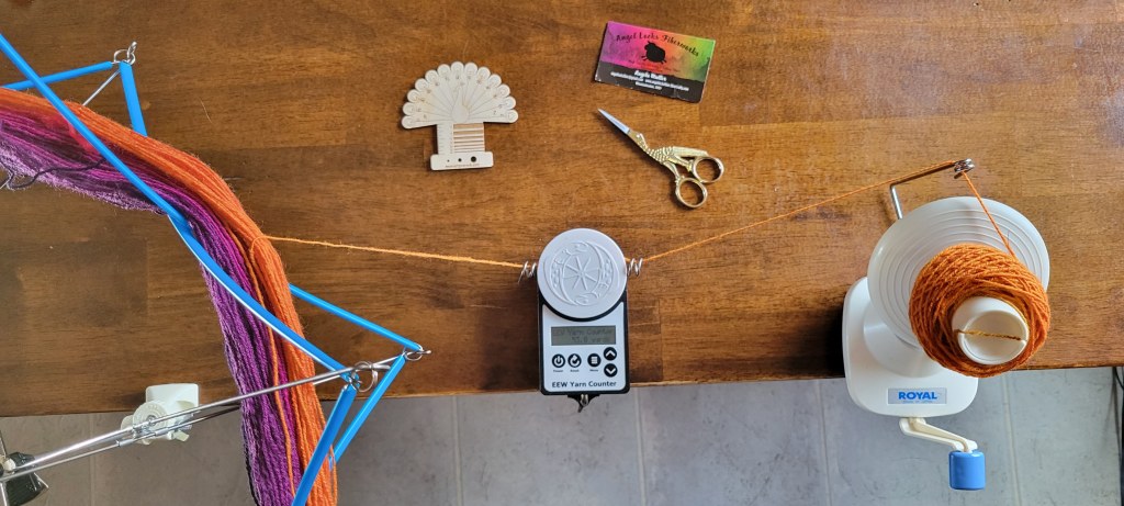 Overhead view of counting yardage while winding from a skein on the left into a ball on the right