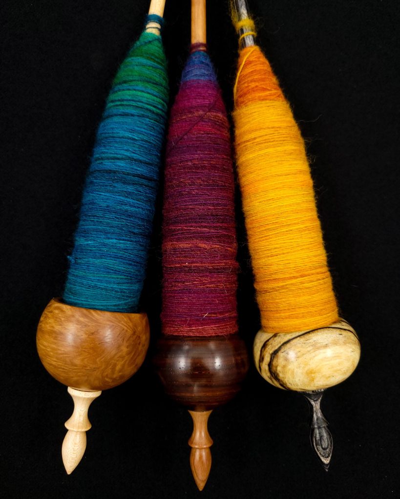 Three Spanish Peacock ninja spindles with spun fiber