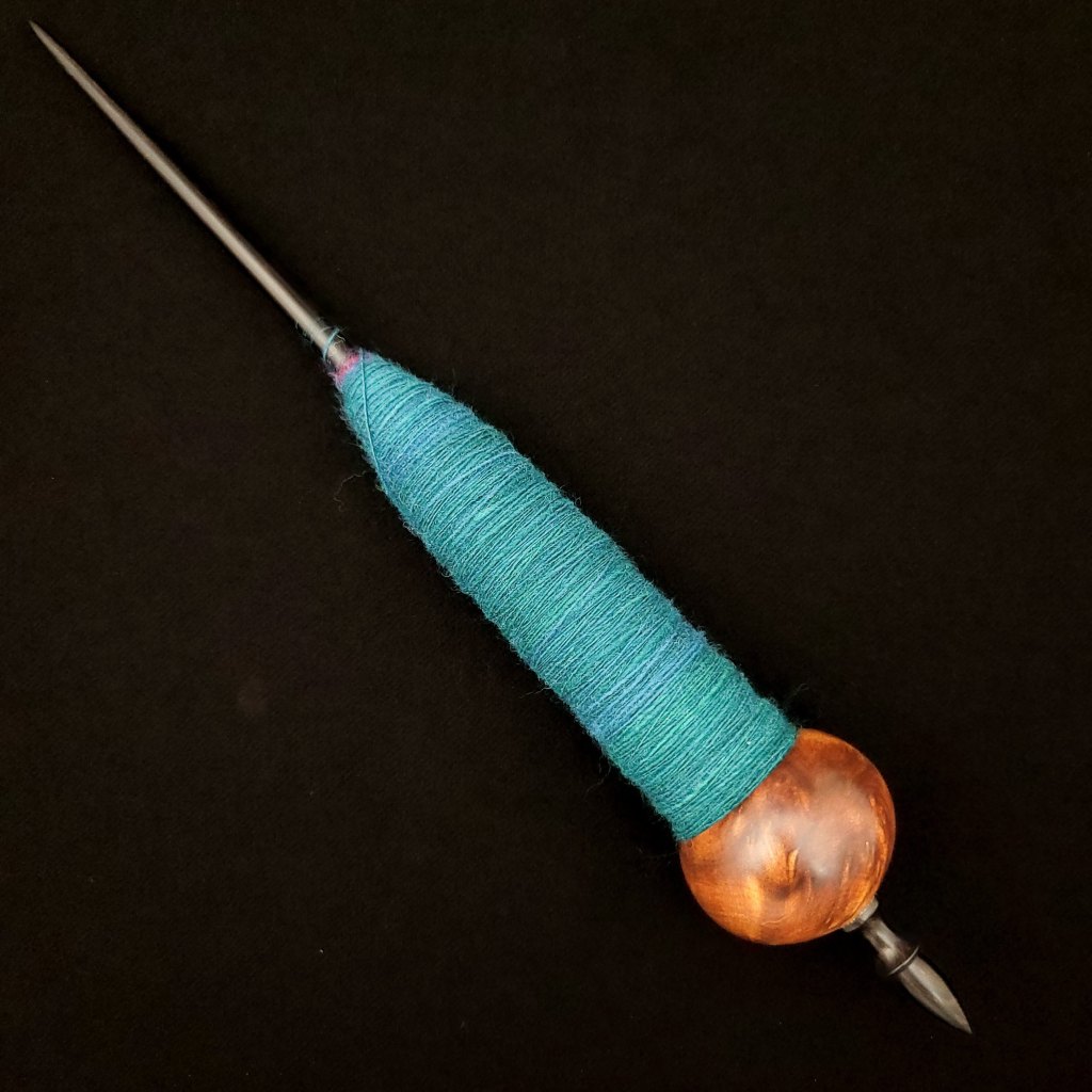 The fifth Spanish Peacock ninja spindle with blue spun fiber