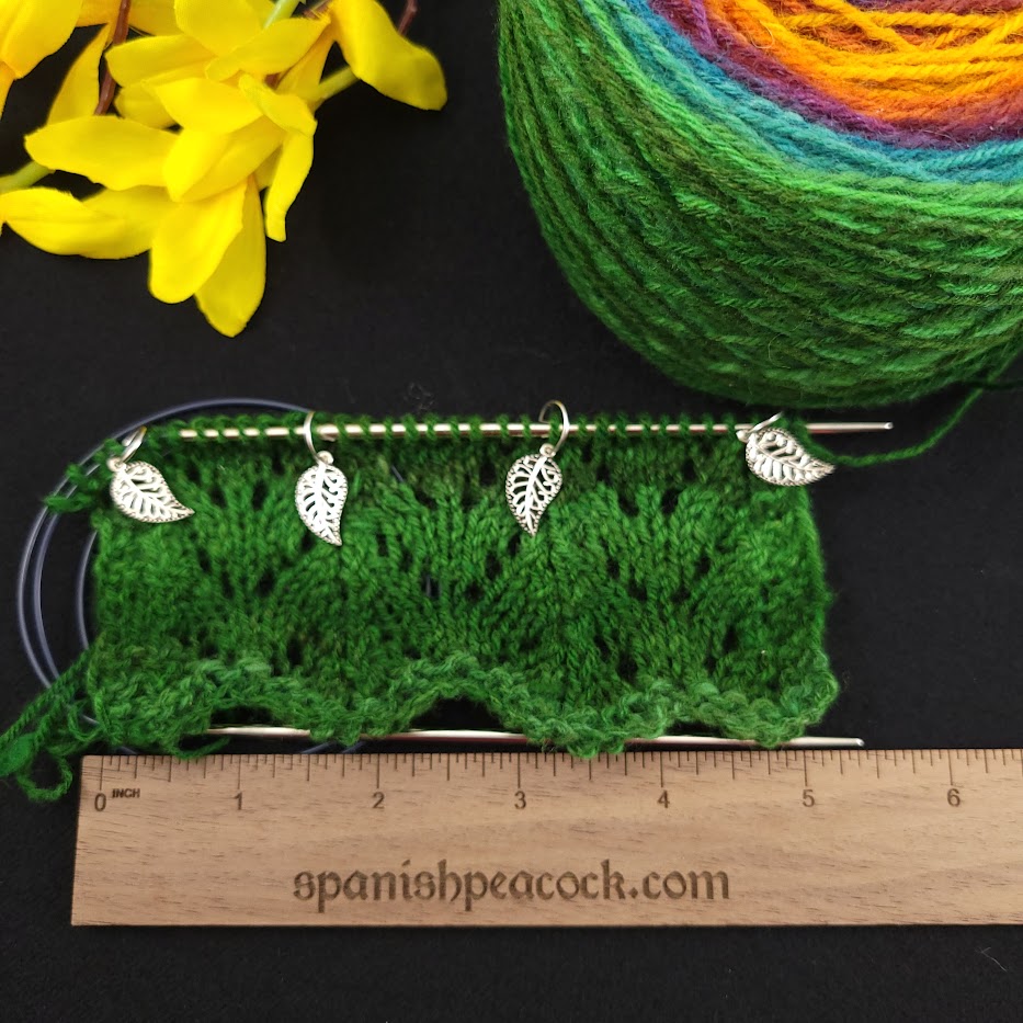 A knitting swatch measured against a ruler