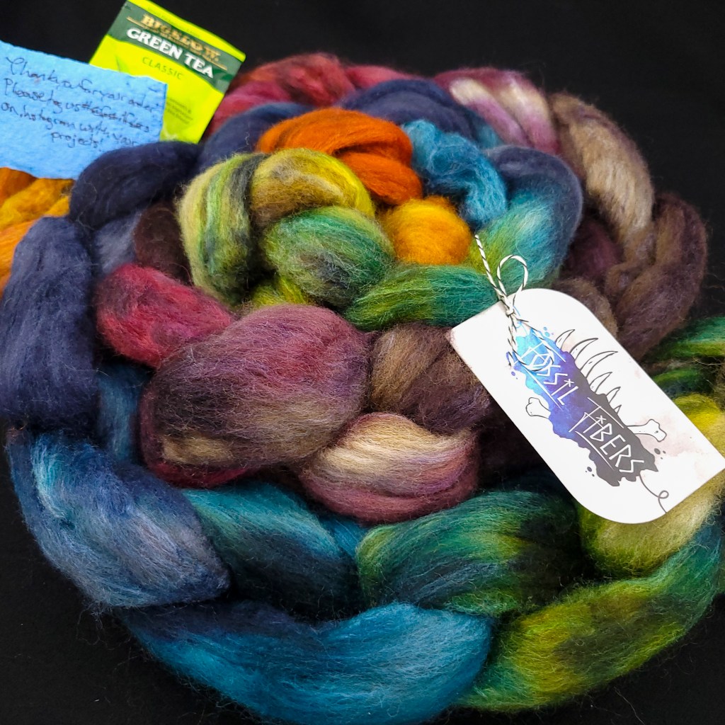 Two braids of Bluefaced Leicester/silk blend coiled up together