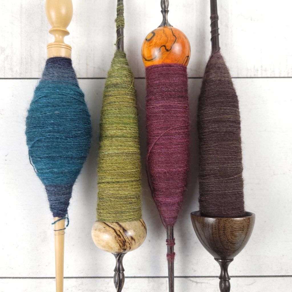 Four supported spindles that made up singles #1 on my Tour de Fleece spin