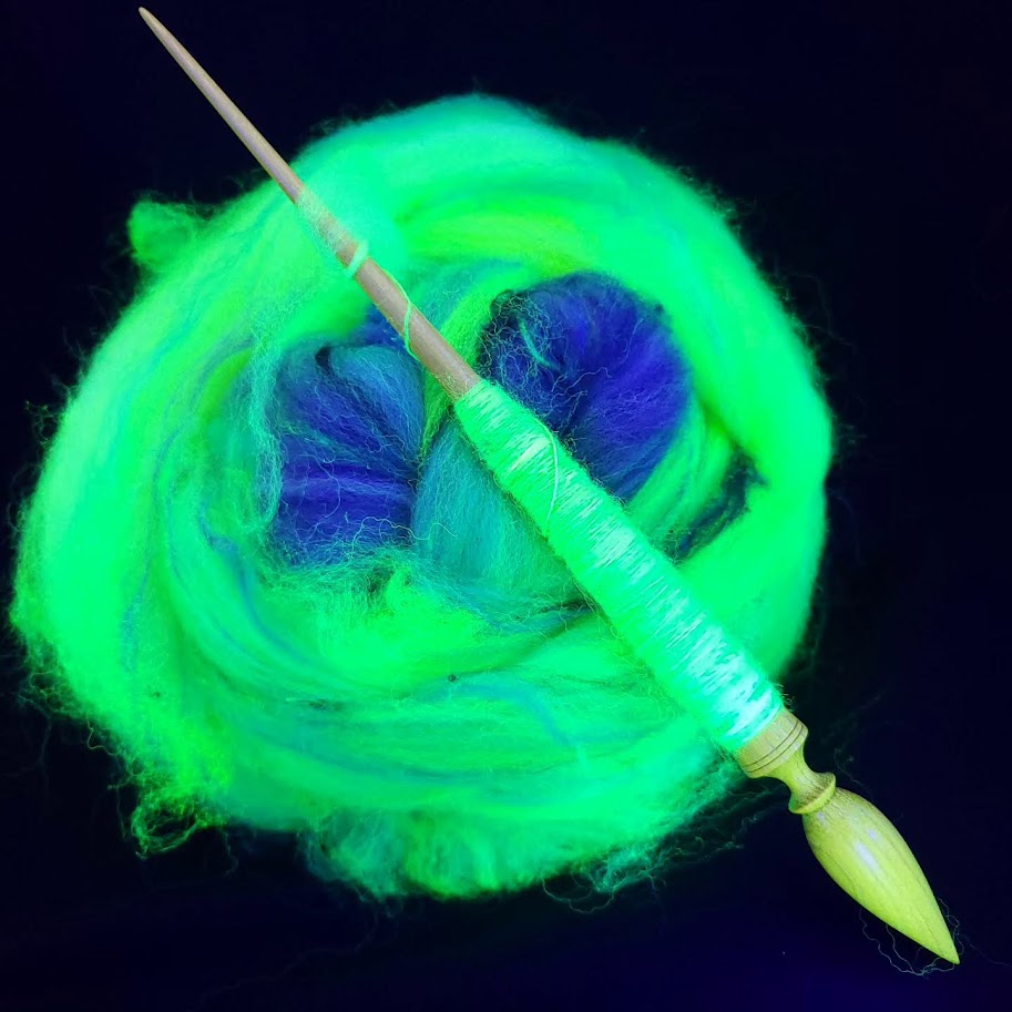 A spindle propped up on a ball of fiber