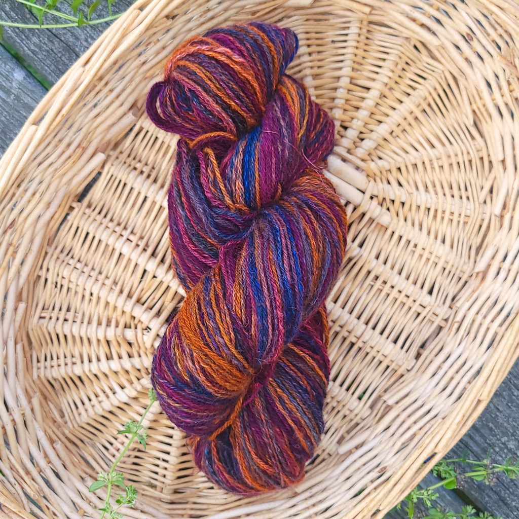 A finished skein of yarn rests in a basket